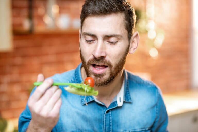 man enjoying fresh salad